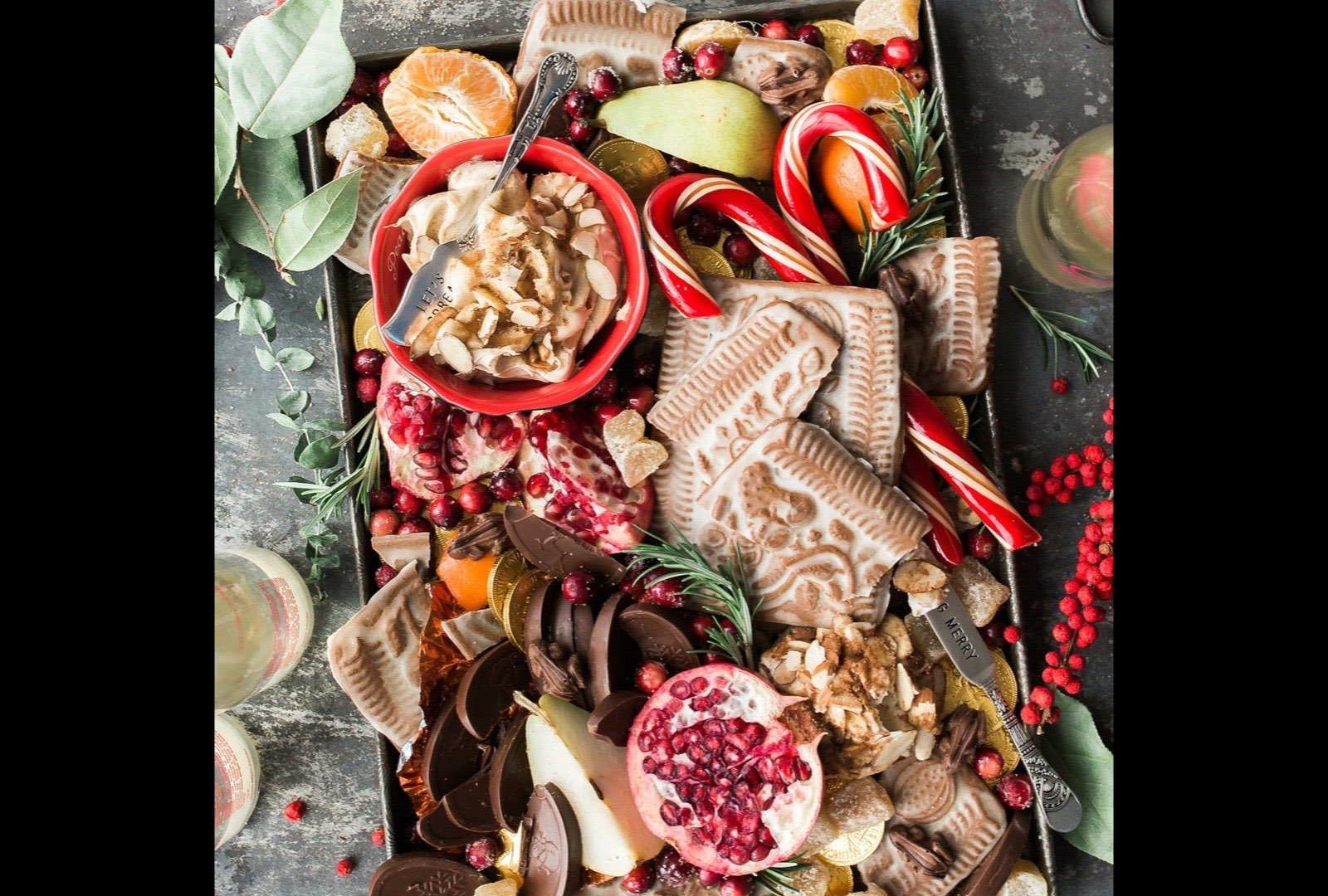 Festive sweet grazing tray with candy canes, chocolate and pomegranate — Christmas catering in Yorkshire by Jack Robinson Catering